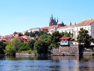 Obraz premium view of Prague from the deck of a steamer, historical city center, panorama on the Vltava, sunny summer day, tourism
