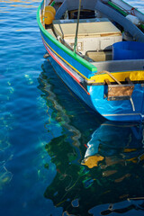 Fototapeta na wymiar Traditional maltese fishing boat with reflection