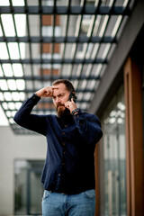 Young businessman talking on the phone outdoors