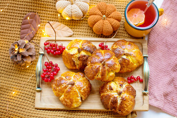 Homemade pumpkin shaped bread located on a dark background.