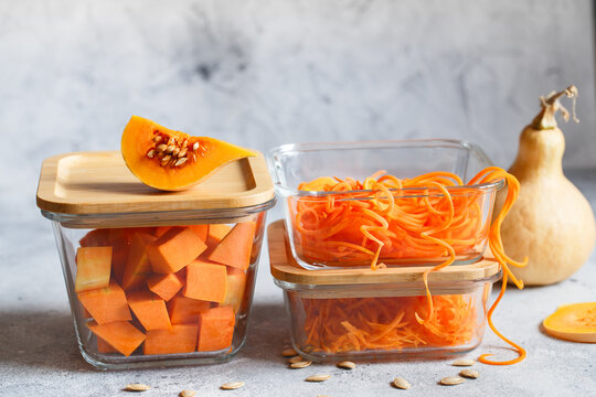 Glass boxes with fresh raw orange vegetables. Finaly shredded pumpkin and big pieces. Healthy Meal Prep, recipe preparation photos. Healthy vegan dishes in glass containers. Weight loss food concept