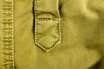 clothing items stonewashed cotton fabric texture with seams, clasps, buttons and rivets, macro