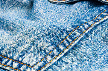clothing items blue stonewashed faded jeans cotton fabric texture with seams, clasps, buttons and...