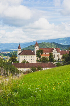 Austria, Carinthia,&Ocirc;&oslash;&Omega;Sankt&Ocirc;&oslash;&Omega;Paul&Ocirc;&oslash;&Omega;im&Ocirc;&oslash;&Omega;Lavanttal, Springtime meadow with&Ocirc;&oslash;&Omega;Saint Pauls Abbey in background