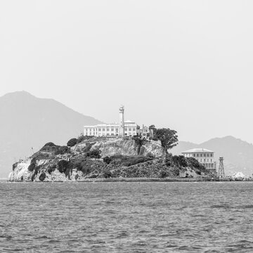 Waterfront with Alcatraz Island in background against sky at San Francisco, California, USA