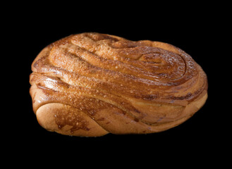 Sweet ruddy freshly baked bun on black background