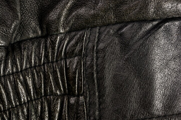 Old vintage genuine soft black leather texture background, top layer with pores and scratches, macro, close-up