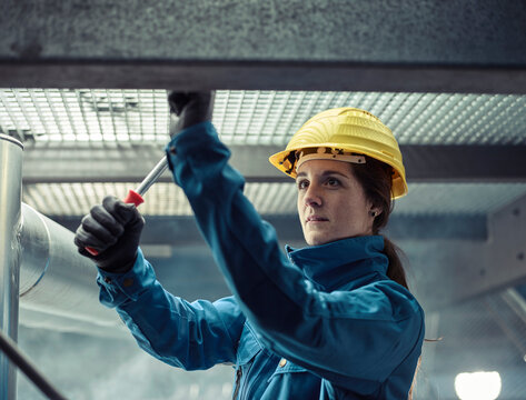 Craftswoman wearing hard hat at work