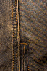 clothing items stonewashed cotton fabric texture with seams, clasps, buttons and rivets, macro