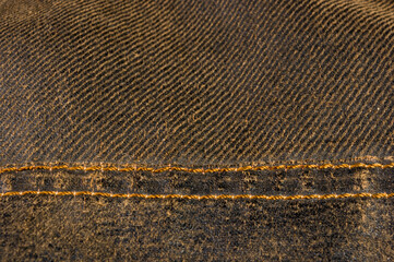 clothing items stonewashed cotton fabric texture with seams, clasps, buttons and rivets, macro