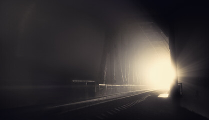 Night, illuminated railway bridge in black and white tones