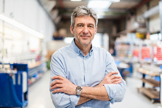 Smiling businessman in production hall