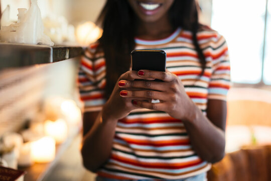 Woman's hands holding smartphone, close-up