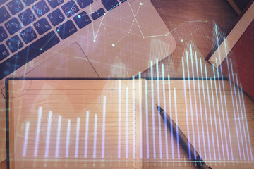 Stock market chart and top view computer on the table background. Double exposure. Concept of financial analysis.