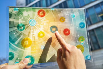 Hand holding futuristic device with digital icons