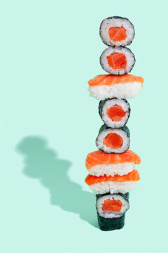 Salmon sushi with nigiri and maki pattern on mint green background