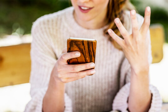 Woman's hand holding smartphone, close-up