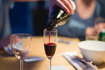 Pouring red wine into glass