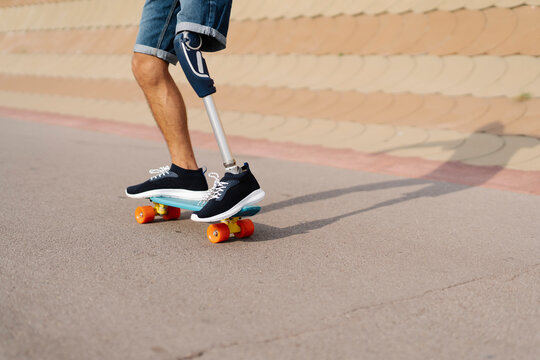 Disabled athlete skateboarding at sports court
