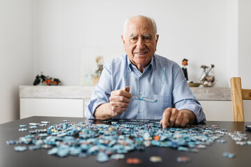 Senior man doing a jigsaw