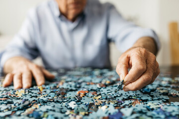 Senior man doing a jigsaw