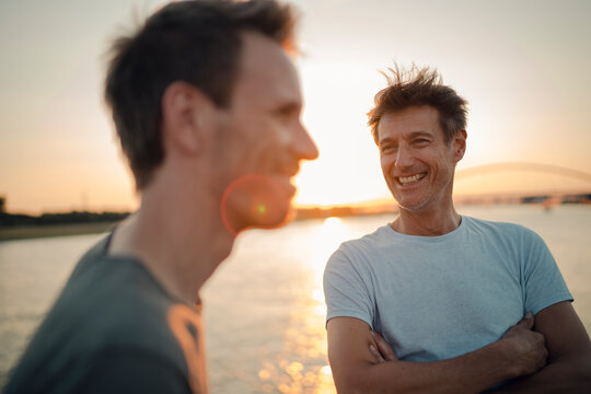 Two friends meeting at sunset, spending the evening talking