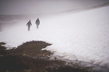 silhouette of a person in foggy mountains