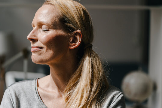 Portrait of smiling woman's face in sunlight