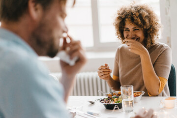 Colleagues joking at lunch break, eating healthy food