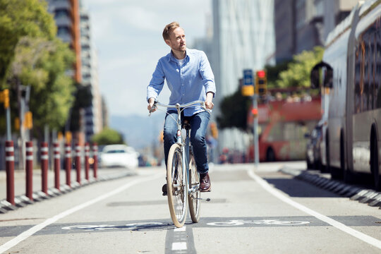 Man with bike on bicycle lane