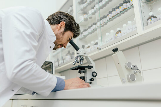 Man using microscope in laboratory
