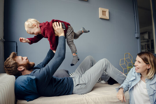 Happy family playing with their son at home