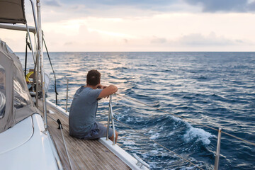 Indonesia, Lombok island, man sitting on deck of a sailing boat