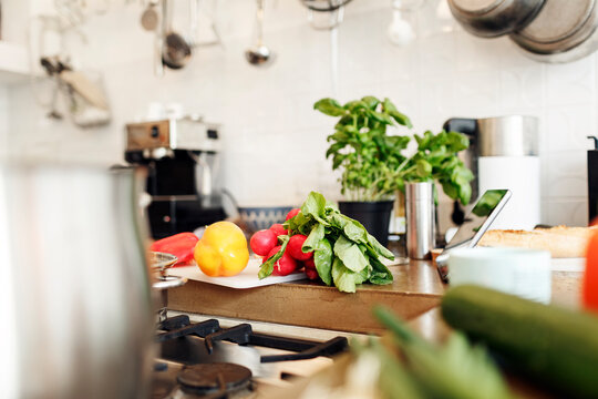 Vegetables and tablet on kitchen counter