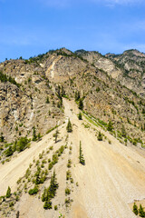 Sand and rocks spreading out under mountain range.