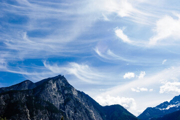 Fototapeta na wymiar Cirrus clouds spreading into curves above mountains.