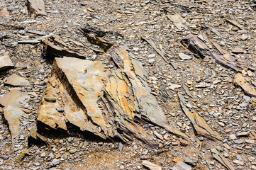 Detail of layered rocks and gravel on ground.