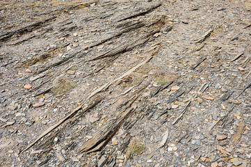 Abstract detail of parallel layered rocks and gravel.