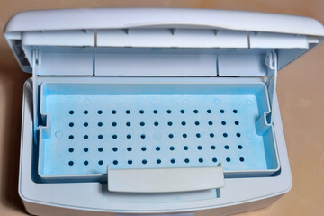 sanitizing box for processing manicure, pedicure and hairdressing tools in a solution disinfectant