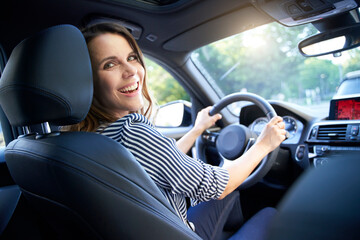 Happy woman driving car