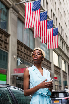 USA, New York, young blonde african-american woman with smartphone