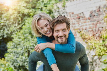 Portrait of happy couple in garden of their home