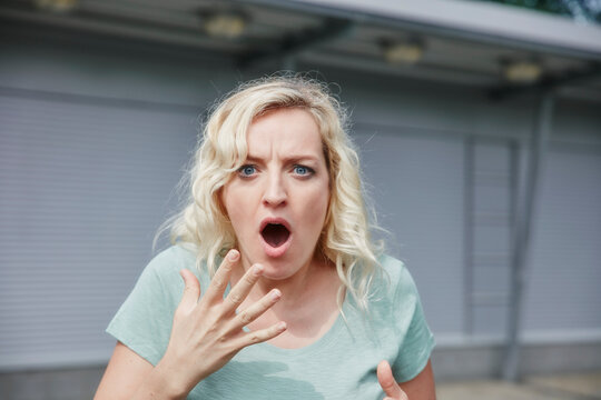 Portrait of shocked woman outdoors