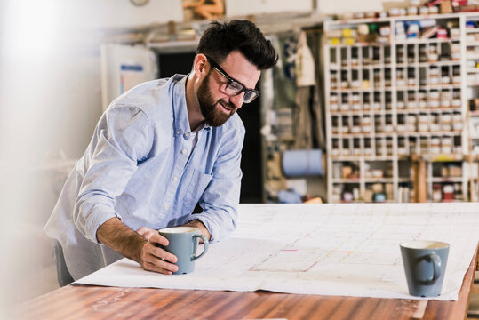 Smiling man looking at construction plan