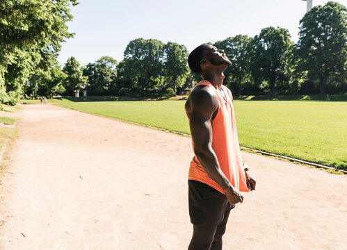 Young athlete exercising on sports field, looking up