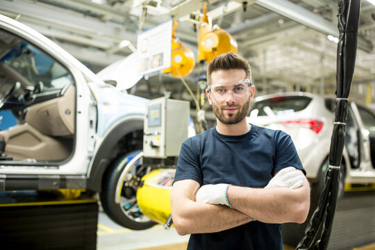 Portrait of confident worker in modern car factory