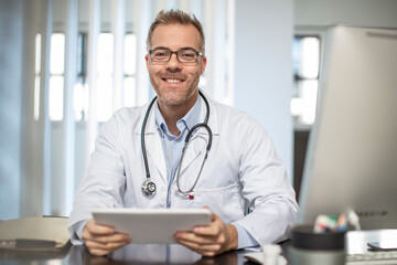 Portrait of smiling doctor in medical practice