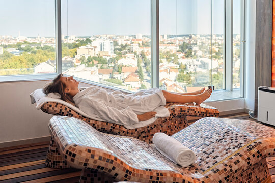 Senior female reclining on lounge chair at health spa