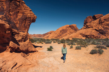 Woman exploring Valley of Fire State Park in summer, Nevada, USA