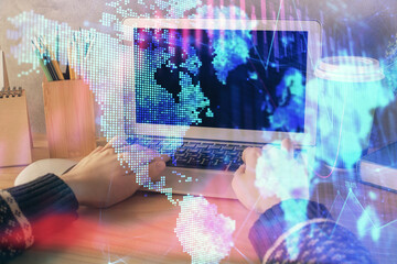 Double exposure of woman hands typing on computer and forex chart hologram drawing. Stock market invest concept.